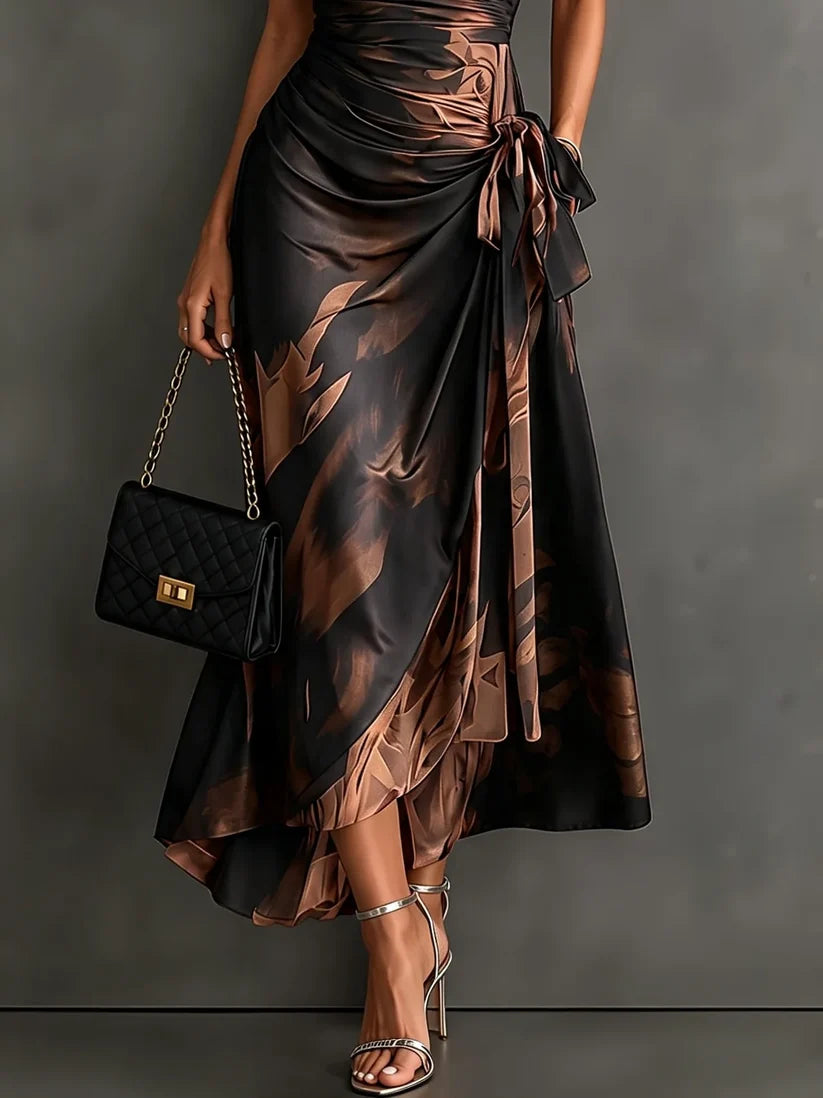 Natalia | Robe midi croisée à imprimé abstrait rouge et noir, encolure en V, manches courtes, ceinture et ourlet asymétrique à volants.