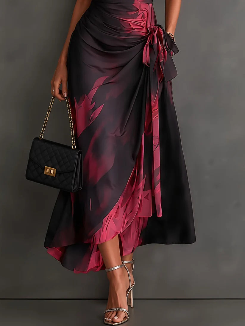 Natalia | Robe midi croisée à imprimé abstrait rouge et noir, encolure en V, manches courtes, ceinture et ourlet asymétrique à volants.